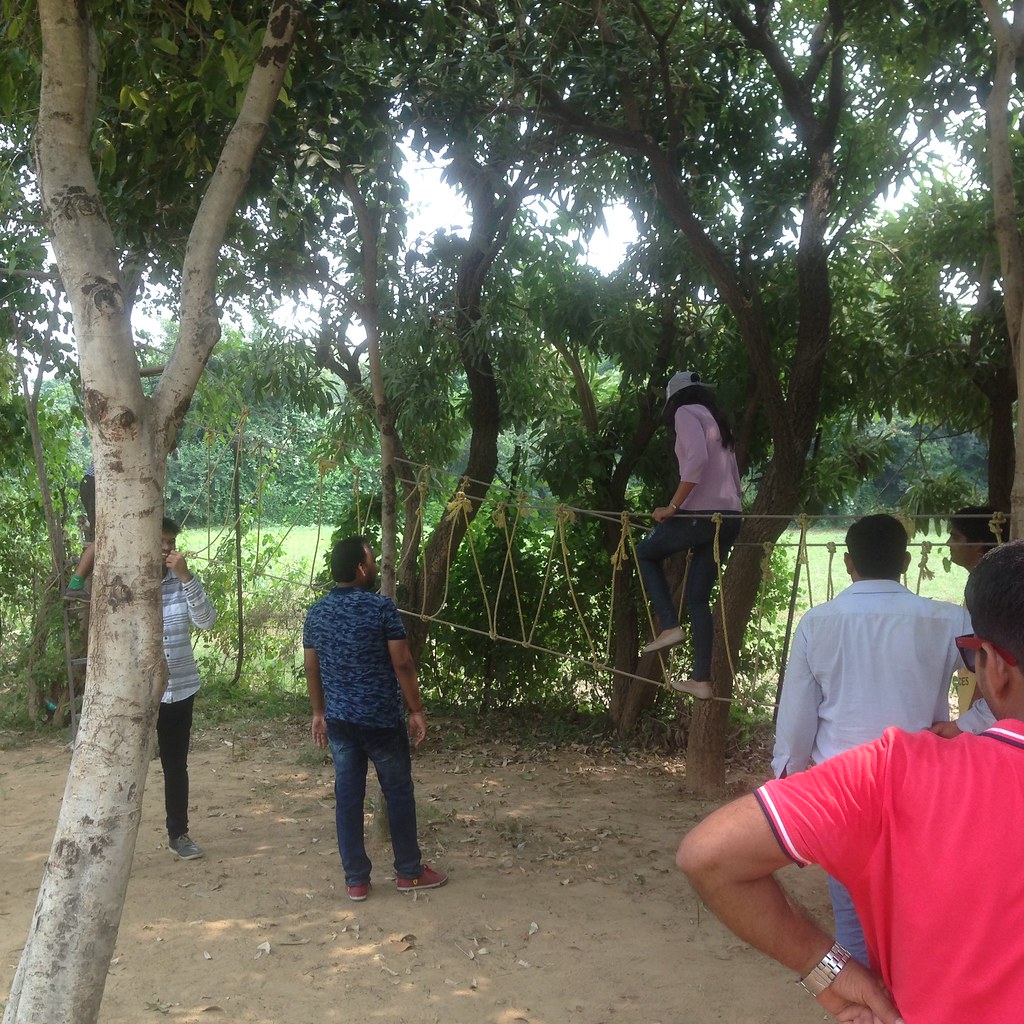 Female employee enjoying rope crossing Peoplestrong tech team outing Yr 2016 AskDushyant